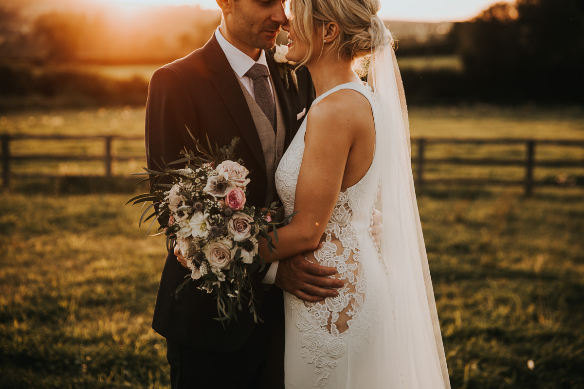 Hyde house wedding photography cotswolds, bride and groom having photographs at golden hour sunset